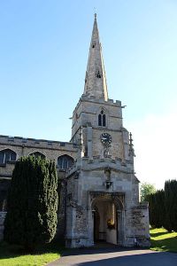 St Andrew's church, Chesterton. Anna Maria's memorial is on the wall to the left of the porch (here hidden by the yew tree).