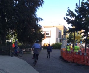 Cyclists speed across the pavement at the War Memorial.