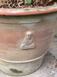 The sphinx theme is repeated in the garden's flower pots.