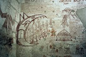 The walls of the Inquisition cells show graffiti by the prisoners: several are in English.