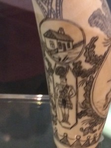 A Scots soldier below a cottage.