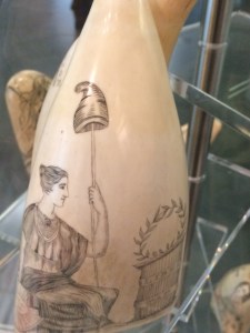 The personification of Liberty sits by an altar.