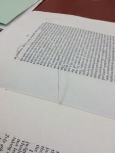 Stitching the booklet.