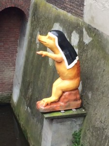 Porcine nun (or nun-like pig) sitting above the canal.
