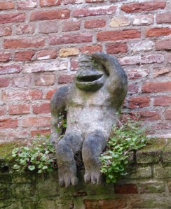 A monkey salutes the passing boat.