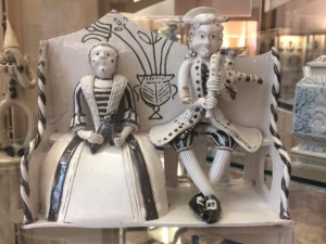 Bagpipe music. The apparently symmetrical vase of flowers in the back of the settle is a familiar motif.