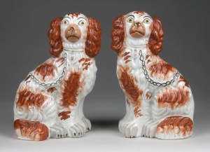 A pair of highly decorated Staffordshire dogs.