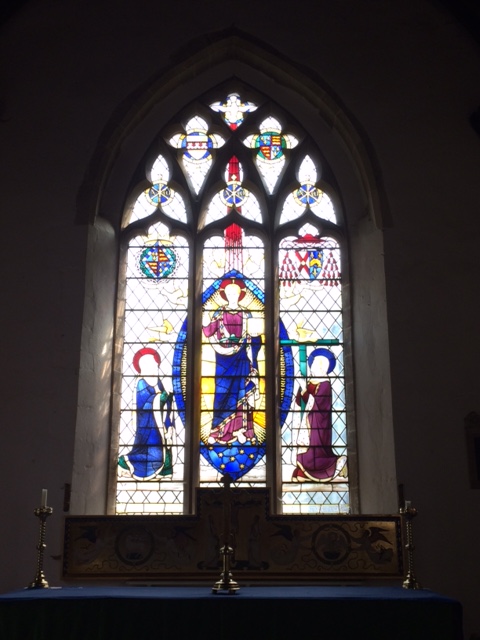 The east window: Lady Margaret's arms are above St Mary, and Bushop Fisher's (with cardinal's hat) above St Helena.