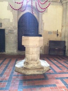 The tower floor has a maze pattern in the titling which is most unusual. The font is centred in the tower, and the ropes of the eight-bell peal can be seen above it.