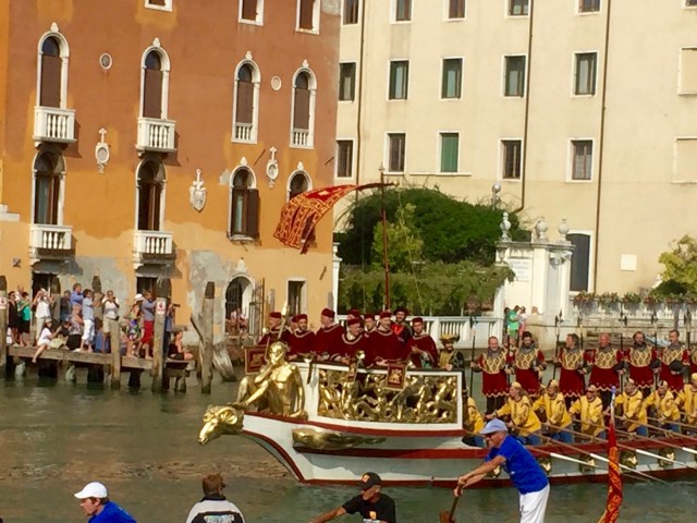 Trumpeters in the prow of a boat in the procession.